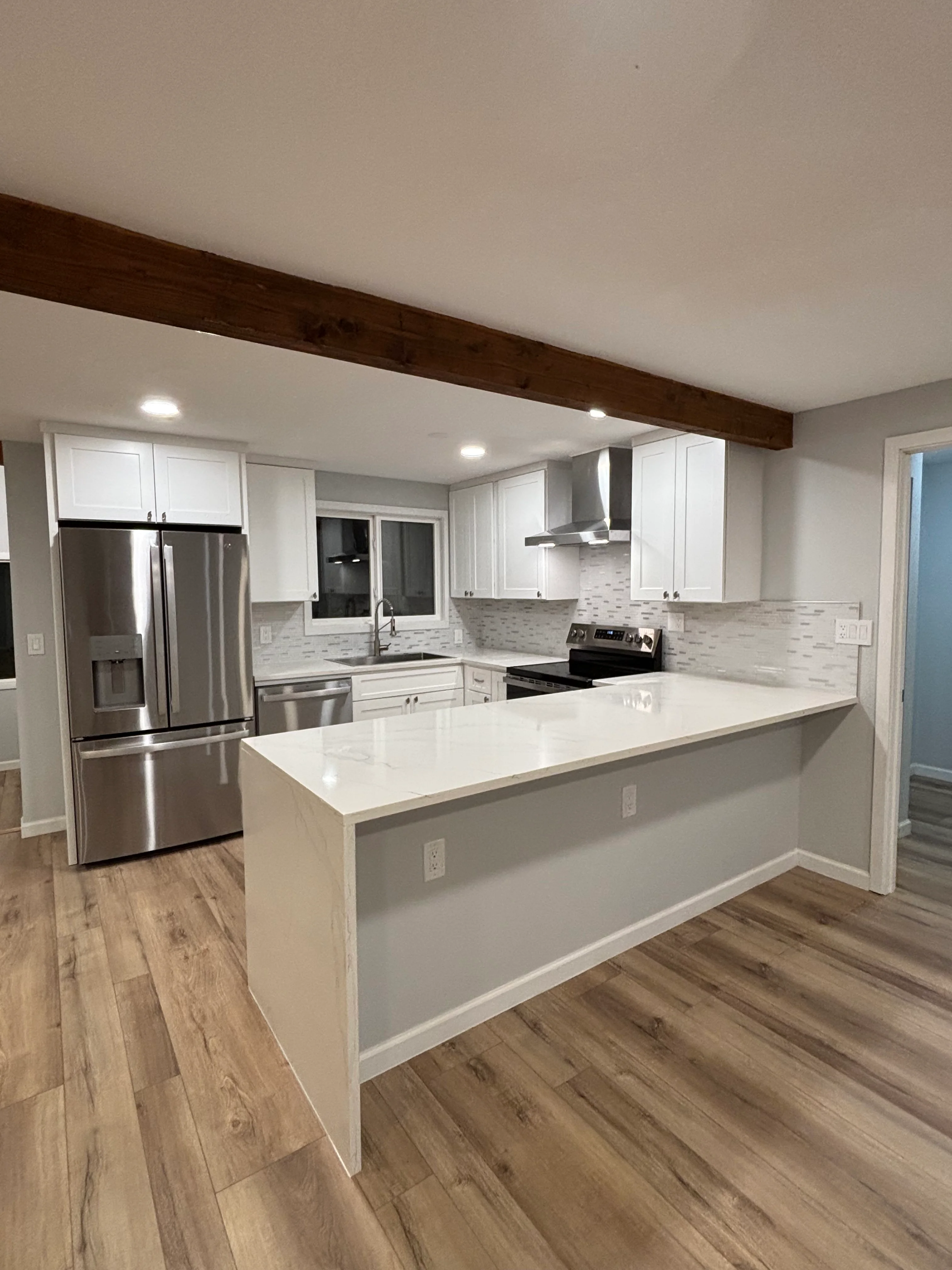 Kitchen with custom cabinets and tile backsplash